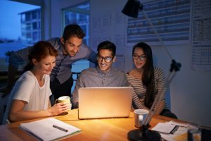 Passionate about their careers. Shot of coworkers working into the evening in the office.